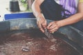 Hand putting coconut coir in plastic bag for grafting plant tree