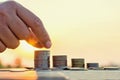 Hand putting coin on coins stack with Concept Royalty Free Stock Photo