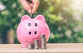 Hand putting a coin into piggy bank. planning savings money of coins to buy a home Royalty Free Stock Photo