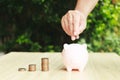 hand putting coin on the piggybank on table.business finance and saving money investment , Money coin stack growing with piggy Royalty Free Stock Photo