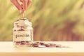 Hand putting Coins in glass jar for time to money saving for pe Royalty Free Stock Photo