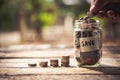 Hand putting coins in jar with money stack step growing growth Royalty Free Stock Photo