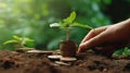 Hand putting coins with plant growing on coin stack over green blurred background. Business finance strategy, money