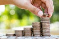 Hand putting coins to coin stack growing graph Royalty Free Stock Photo