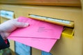 A hand putting the documents for the postal vote of the Berlin House of Representatives in a mailbox Royalty Free Stock Photo