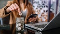 Hand putting mix coins and seed in clear bottle and business investment growth concept. at office Royalty Free Stock Photo