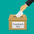 Hand putting paper in the feedback box.