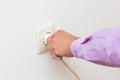 Hand Putting Plug Into Electricity Socket