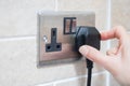 Hand Putting Plug Into Electricity Socket