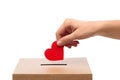 hand putting red heart into charity donation box Royalty Free Stock Photo