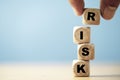 Hand putting risk wording print screen on wooden block cube for financial banking risk analysis and management ,Low risk low Royalty Free Stock Photo