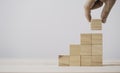 Hand putting and stacking blank wooden cubes on table with copy space for input wording and infographic icon Royalty Free Stock Photo