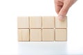 Hand putting and stacking blank wooden cubes on table with copy space for input wording or infographic icon Royalty Free Stock Photo