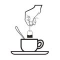 Hand putting tea bag into tea cup Royalty Free Stock Photo