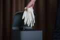 Hand putting used dirty surgical glove to  a garbage bin. Mask protect dust and corona virus in trash Royalty Free Stock Photo