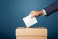 hand putting vote paper into ballot box, generative ai Royalty Free Stock Photo