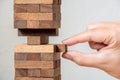 Hand putting wood block stack tower, Concept risk management