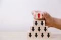 Hand putting wood cube block on top pyramid wooden blocks Royalty Free Stock Photo