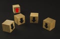 Hand putting wood cube block on top pyramid wooden blocks with red arrows facing opposite to the black arrows. With different Royalty Free Stock Photo