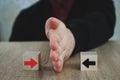 Hand putting wood cube block on top pyramid wooden blocks with red arrows facing opposite to the black arrows. With different Royalty Free Stock Photo