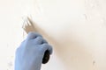 Hand with putty knife repair wall, Hand with a spatula, spatula with spackle paste structure, process of applying layer of putty Royalty Free Stock Photo