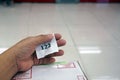 A hand of a queue paper with a pacel box for waitting service in the post office