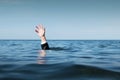 Hand Raised Above the Sea, Businessman Drowning