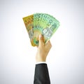 Hand raising money, Australian Dollar bills (AUD) Royalty Free Stock Photo