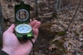 Hand raising prismatic compass on a trail Royalty Free Stock Photo