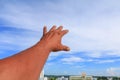 Hand reach up blue sky background Royalty Free Stock Photo