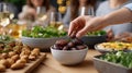 Hand reaches for dates in a bowl, capturing a moment of togetherness during a festive iftar dinner in Ramadan Royalty Free Stock Photo