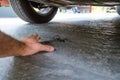 Hand reaches for the keys that fell under the car Royalty Free Stock Photo