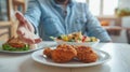 Hand reaching for fried chicken.AI generated image Royalty Free Stock Photo