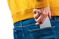 Hand reaching for the mobile phone in jeans back pocket Royalty Free Stock Photo