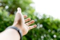 Hand reaching out over green natural light Royalty Free Stock Photo