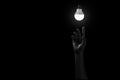 Hand reaching out to light in black, Royalty Free Stock Photo