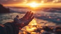 Hand Reaching Out to Sunset Over Ocean Royalty Free Stock Photo