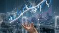 Hand Reaching Out Toward Financial Graph Representing Market Trends and Performance Analysis in Digital Environment with Royalty Free Stock Photo