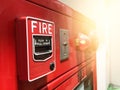 A hand reaching and pulling a red fire alarm switch. red fire alarm Royalty Free Stock Photo