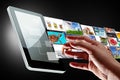 Hand reaching streaming multimedia of the tablet Royalty Free Stock Photo