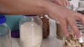 Hand Rearranging Natural Food Jars