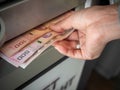 Hand receiving cash money from ATM machine