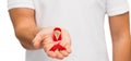 Hand with red aids or hiv awareness ribbon Royalty Free Stock Photo