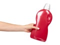 Hand with red detergent bottle, liquid washing soap for textile Royalty Free Stock Photo