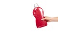 Hand with red detergent bottle, liquid washing soap for textile Royalty Free Stock Photo