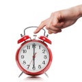 Hand and red old style alarm clock isolated Royalty Free Stock Photo