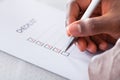 Hand with red pen marking a check box Royalty Free Stock Photo