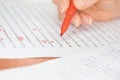 Hand with Red Pen Transcribing a Story Royalty Free Stock Photo