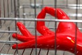 Hand in red rubber glove inside chrome cage