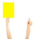 Hand of referee with big yellow card to warn